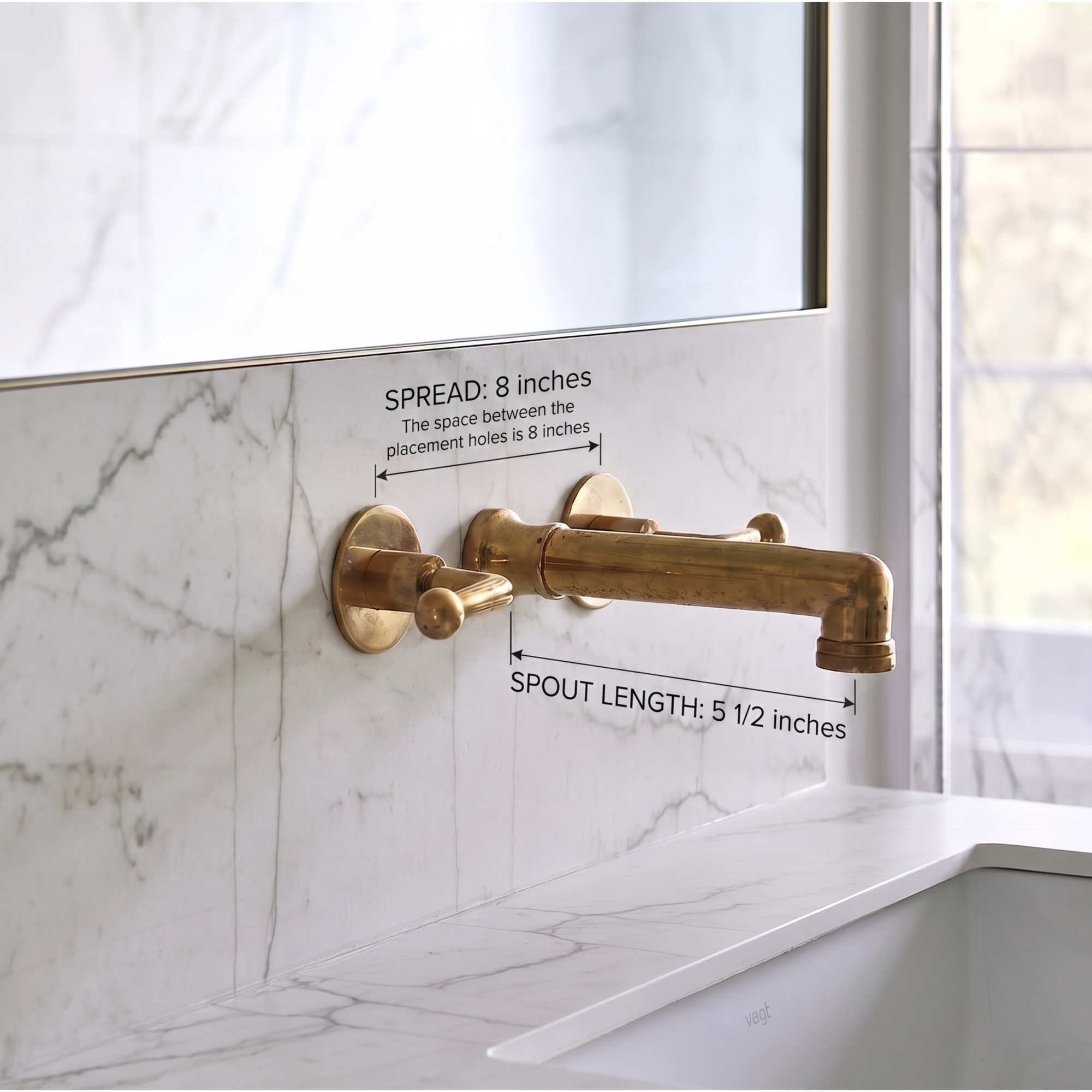 A wall-mounted brass faucet with dimension callouts showing 8-inch spread and 5 1/2-inch spout length, installed against a white marble backsplash.