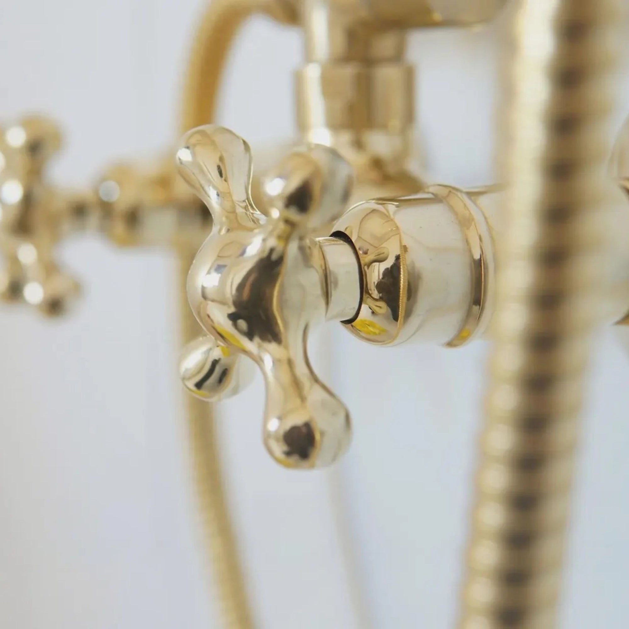 Close-up of a gold faucet and shower head 