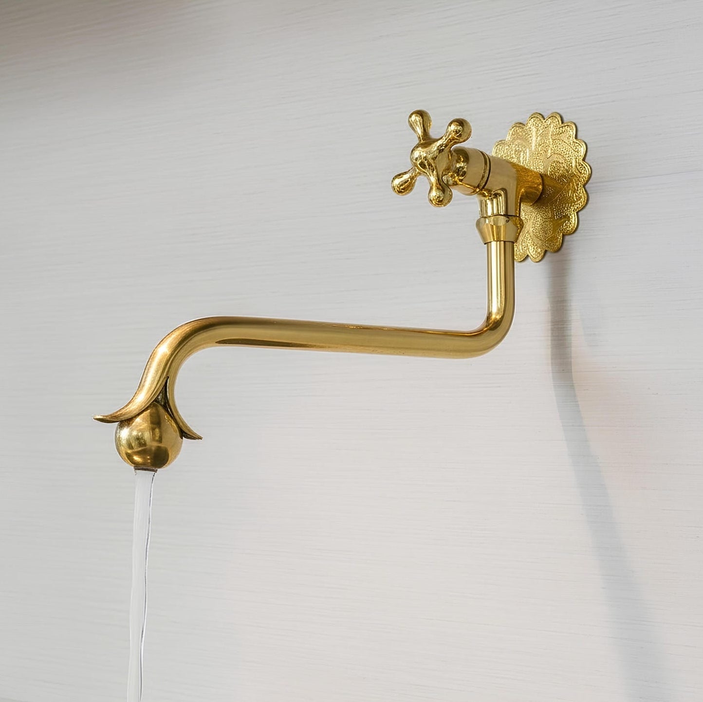     Solid brass Moroccan pot filler faucet mounted on a kitchen wall, featuring a classic decorative design.