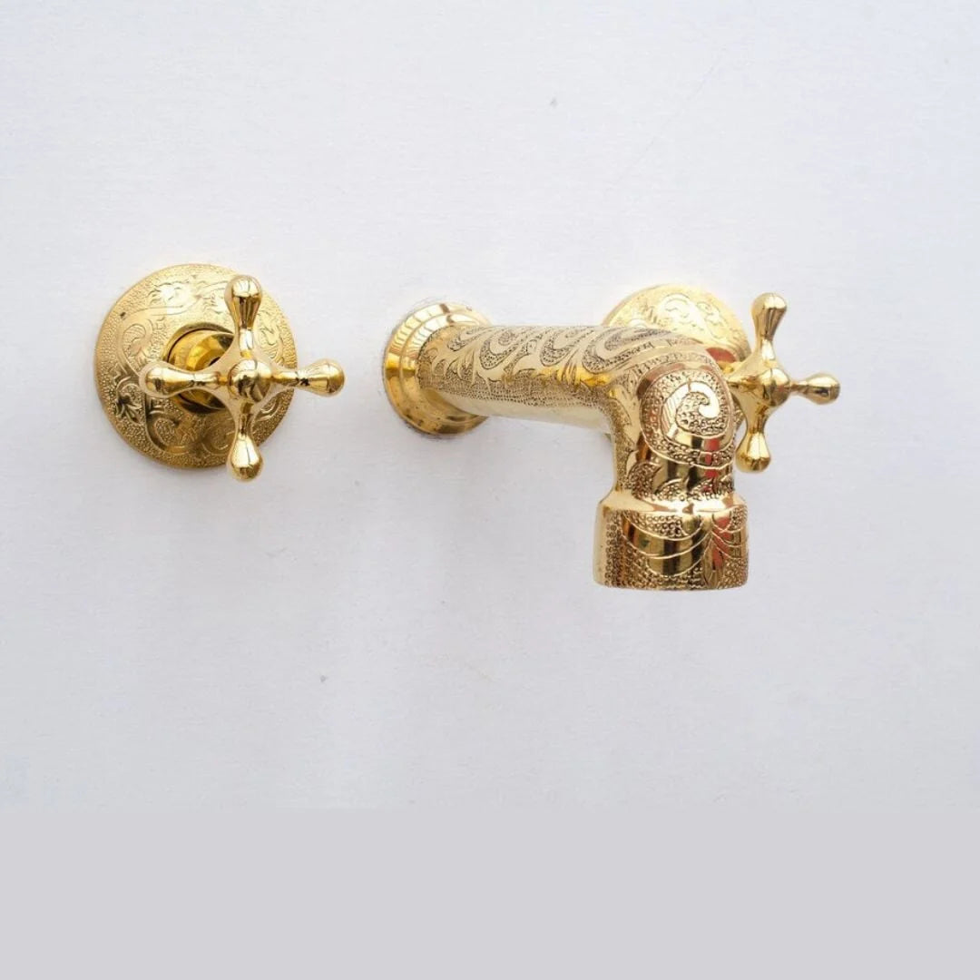 Decorative gold faucet on a white background