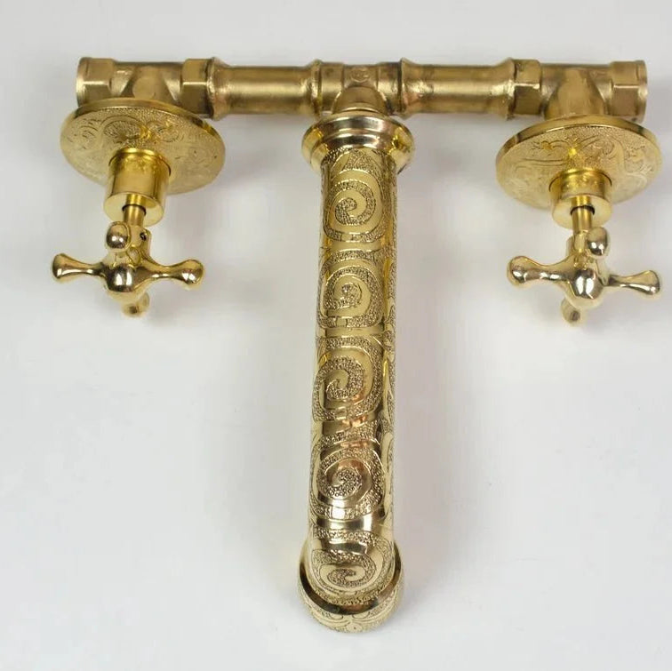 Brass faucet with intricate design on a white background