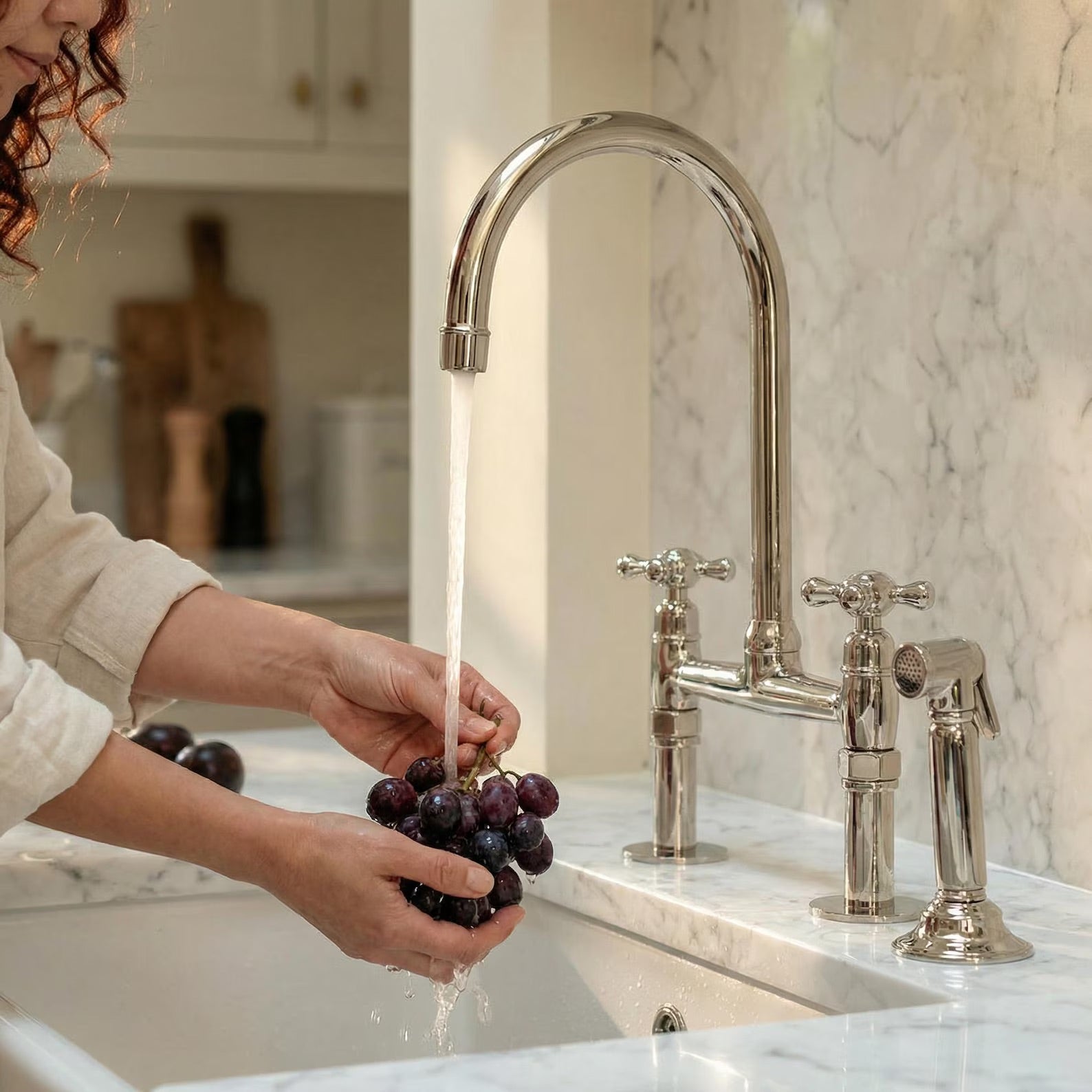 polished nickel bridge faucet with sprayer