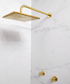 Gold shower head and fixtures on a marble wall