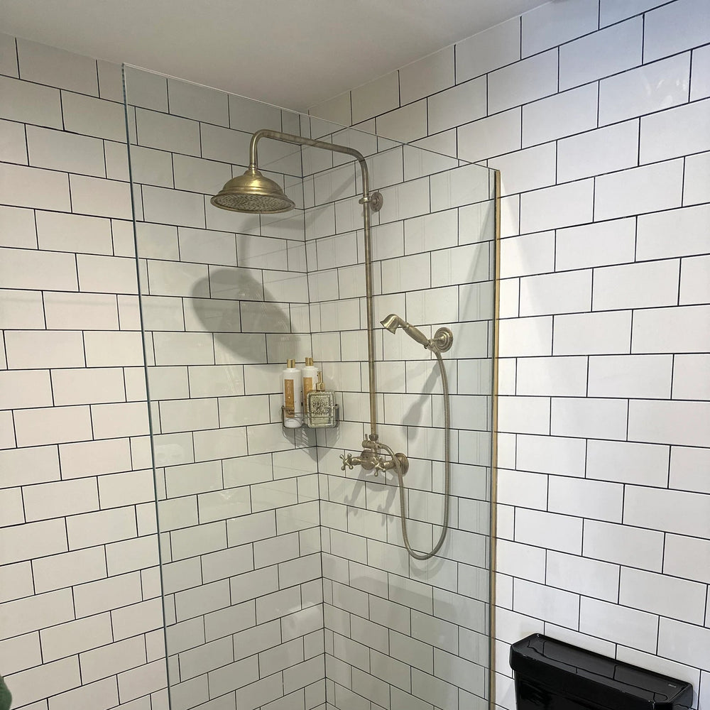 unlacquered brass shower head with shower